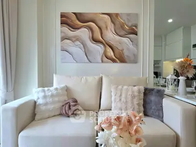 Elegant living room with plush sofa, abstract art, and modern decor in a stylish apartment.