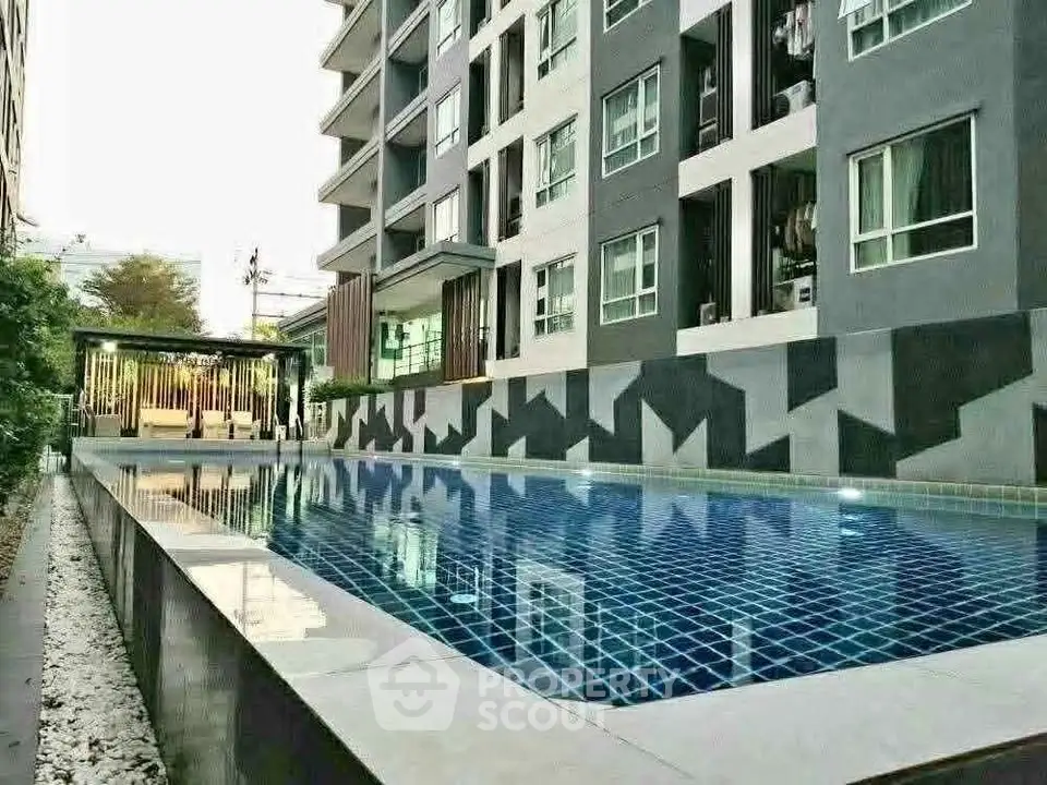 Modern apartment building with a sleek outdoor pool and stylish design.