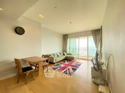 Spacious living room with modern decor and large windows offering stunning views.