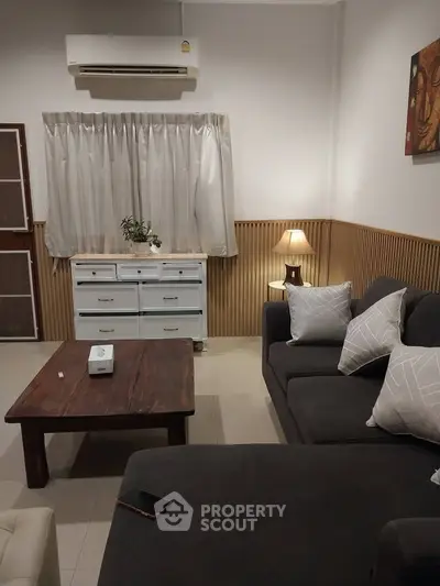 Cozy living room with modern furniture and ambient lighting, perfect for relaxation and entertaining guests.