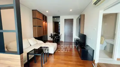 Modern living room with wooden flooring and stylish furniture in a contemporary apartment.