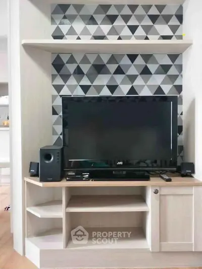 Modern living room with stylish TV unit and geometric wall design