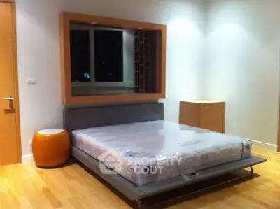 Modern minimalist bedroom with large window and stylish furniture