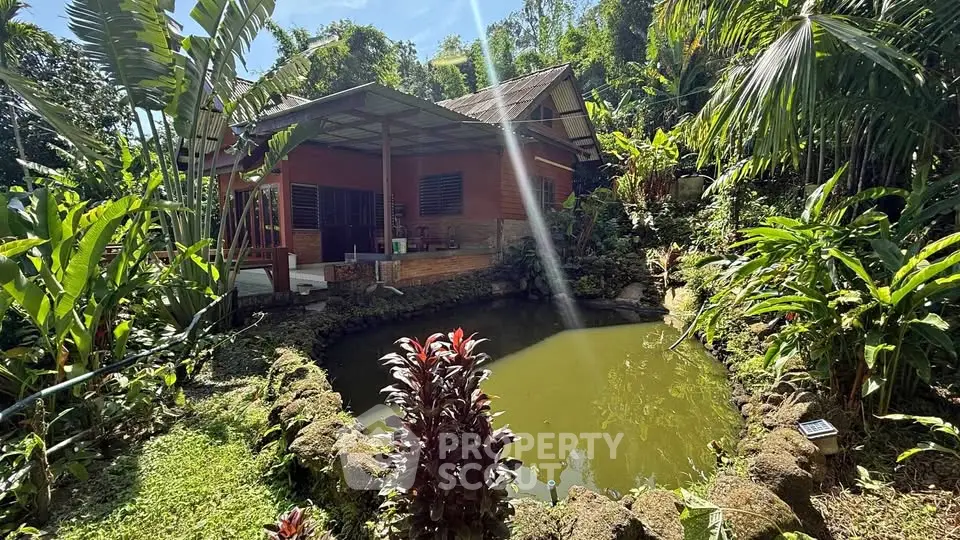 Charming rustic house with lush garden and serene pond, perfect for nature lovers seeking tranquility.