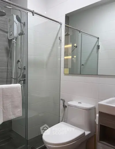 Modern bathroom with glass shower enclosure and sleek fixtures