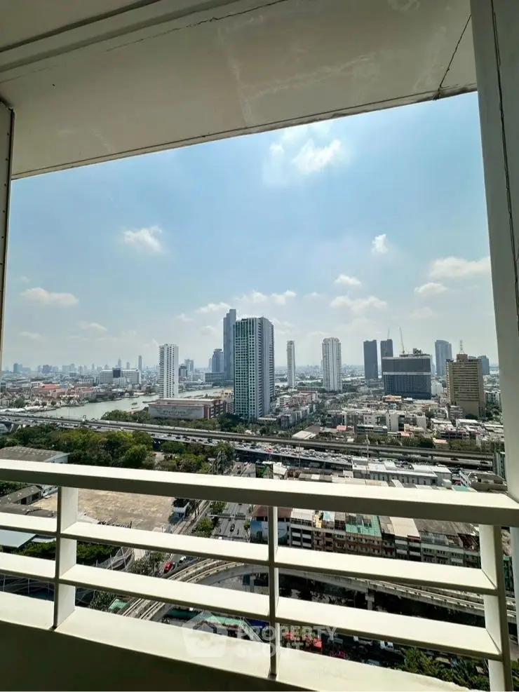 Stunning cityscape view from high-rise balcony with clear blue sky