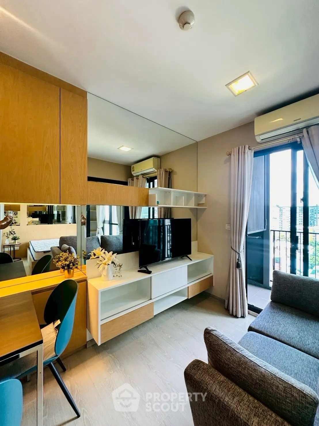 Modern living room with stylish decor and balcony view