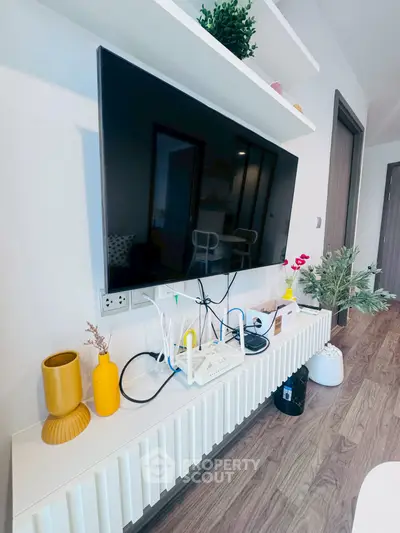 Modern living room with wall-mounted TV and stylish decor