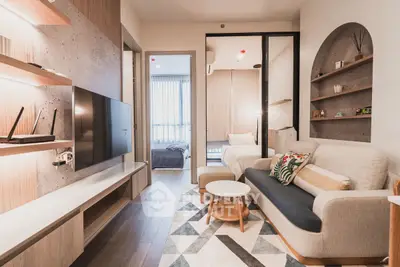Modern living room with stylish decor and open view to bedroom
