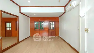 Spacious unfurnished room with wooden accents and air conditioning