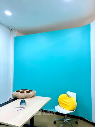 Modern study room with bright blue accent wall and minimalist furniture