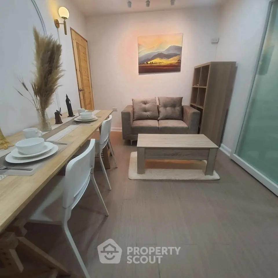 Cozy living room with modern decor and dining area, perfect for urban living.