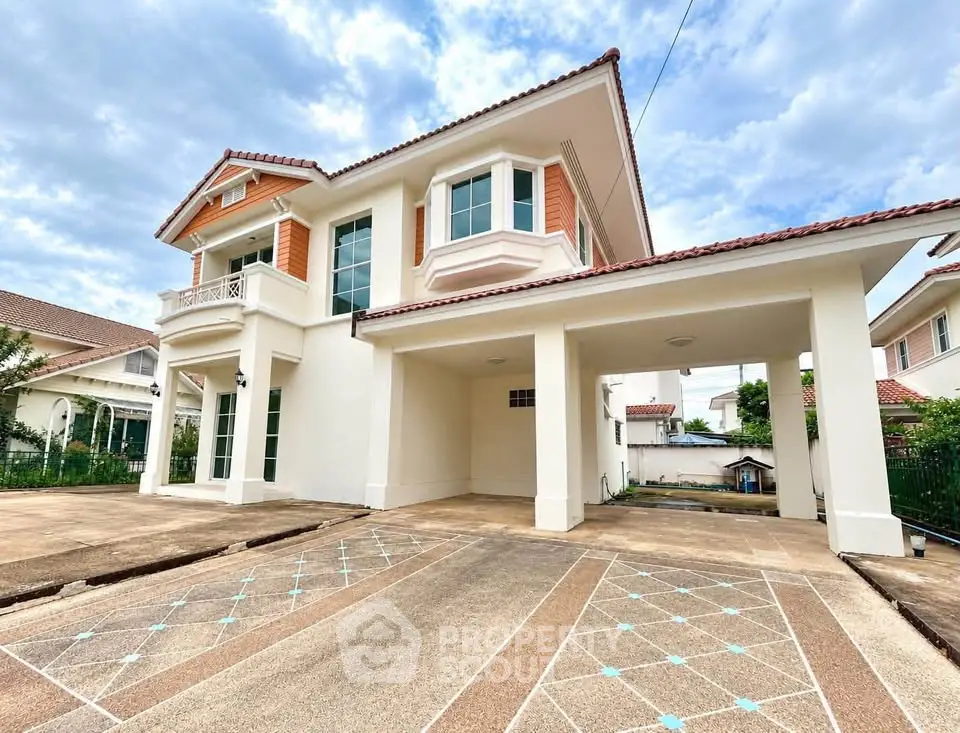 Stunning two-story house with spacious driveway and elegant architectural design.