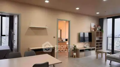 Modern open-plan living room with city view, stylish furniture, and natural light.