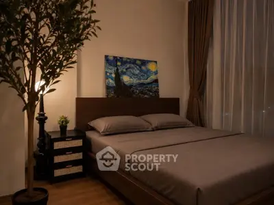 Cozy bedroom with elegant decor and large window, perfect for relaxation and comfort.