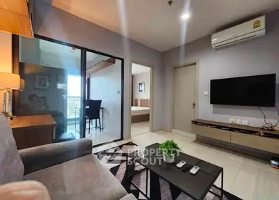 Modern living room with sleek furniture and balcony view in stylish apartment.