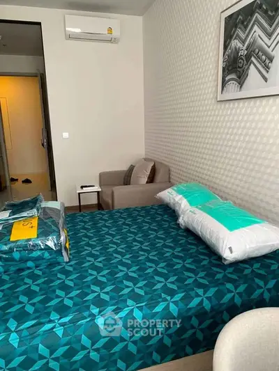 Modern bedroom with stylish decor and air conditioning in a cozy apartment.