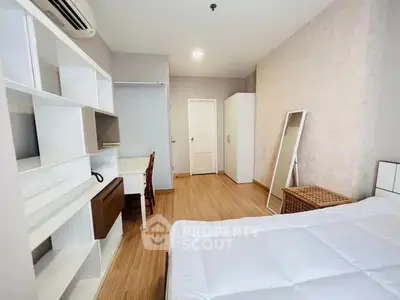 Spacious bedroom with modern furnishings and ample storage in a cozy apartment.