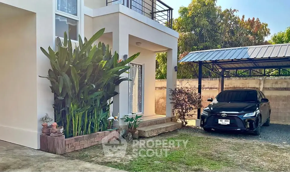 Modern house exterior with lush garden and covered parking space featuring a sleek black car.