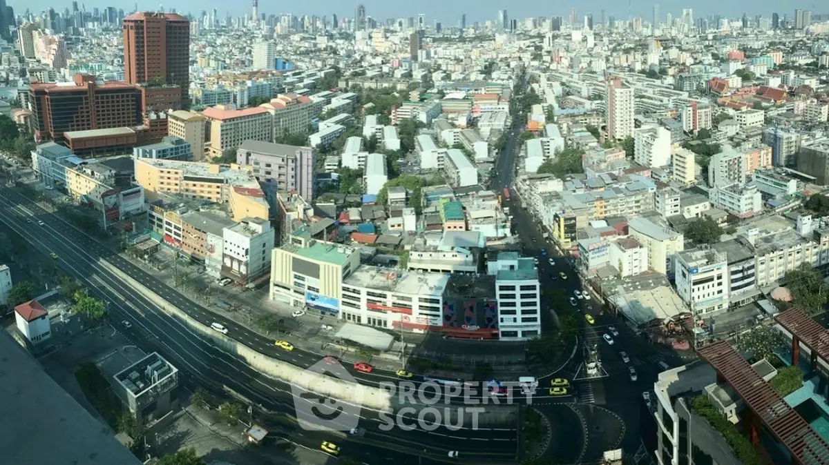 Stunning panoramic cityscape view from a high-rise building, showcasing urban architecture and bustling streets.