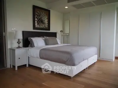 Modern bedroom with stylish decor and wooden flooring in a luxury apartment.