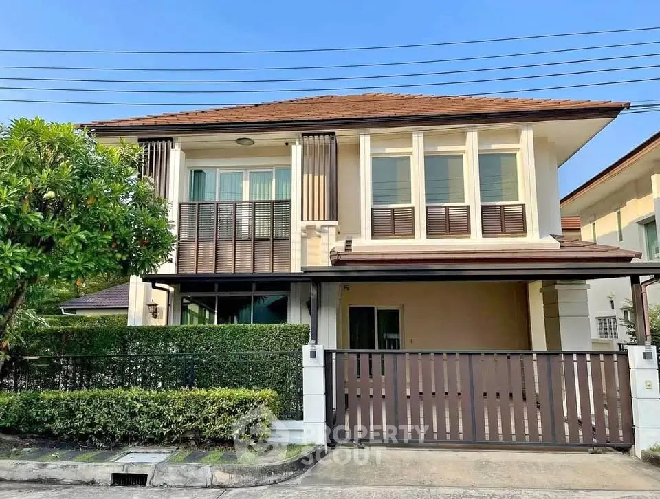 Charming two-story house with modern design and lush greenery in a serene neighborhood.