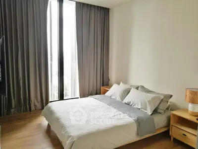Modern bedroom with large window and elegant decor in a stylish apartment.