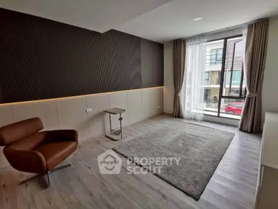 Modern living room with sleek design and large window view