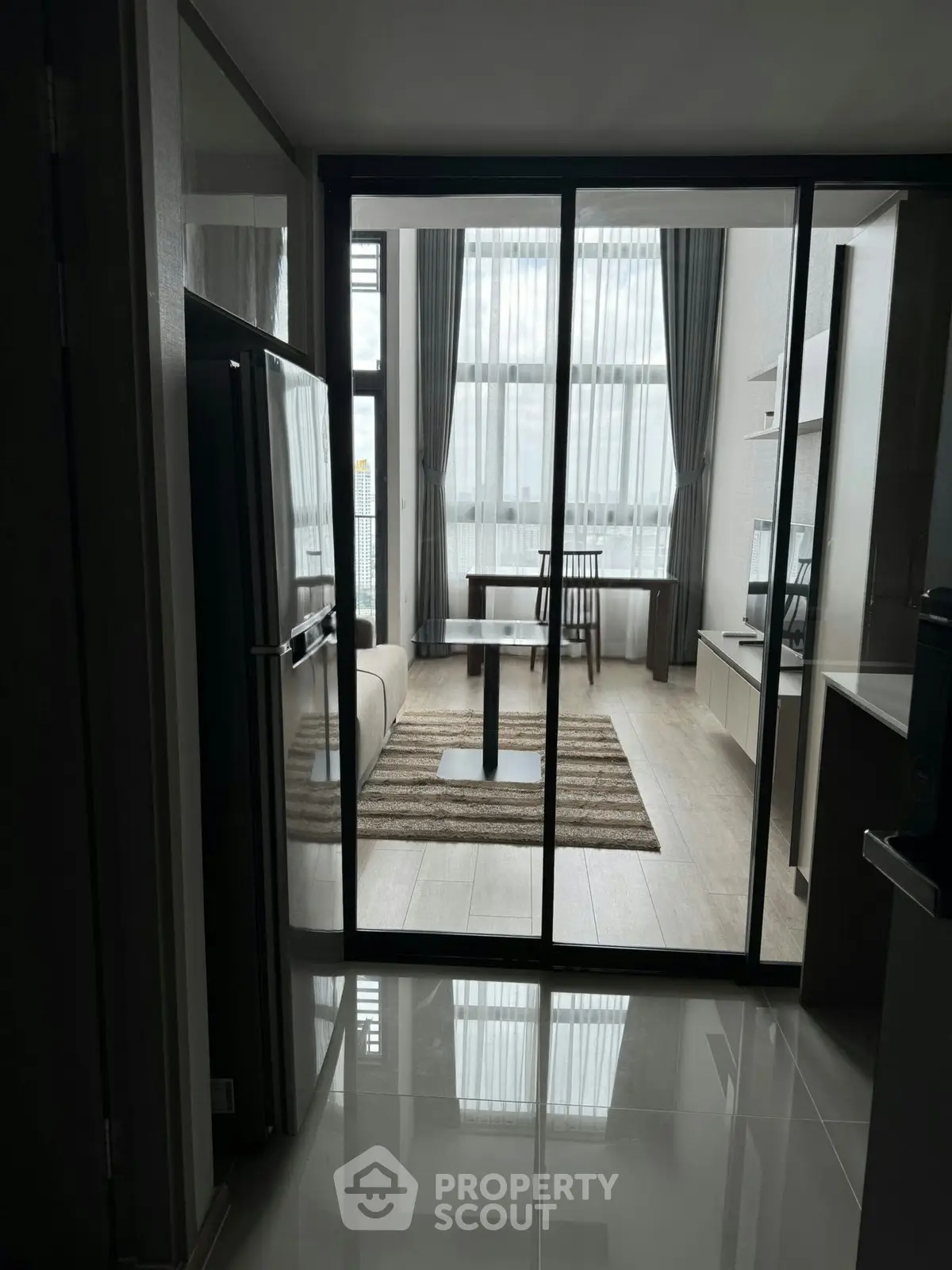 Modern apartment interior with glass partition and high ceilings