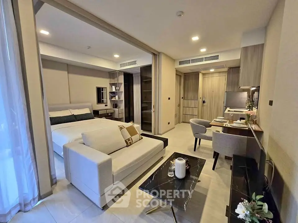 Modern studio apartment with open layout, featuring a cozy living area, stylish bedroom, and elegant decor.
