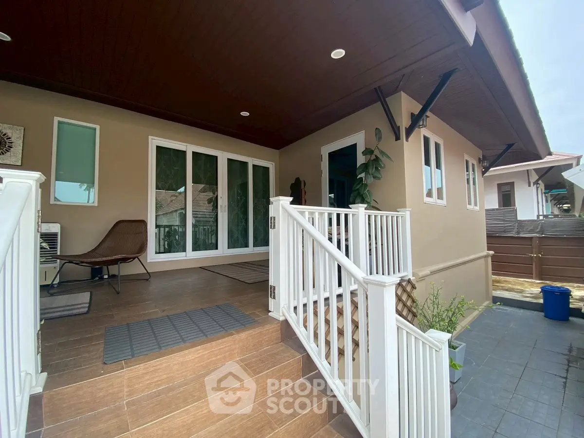 Charming single-story home with inviting porch and modern exterior design.