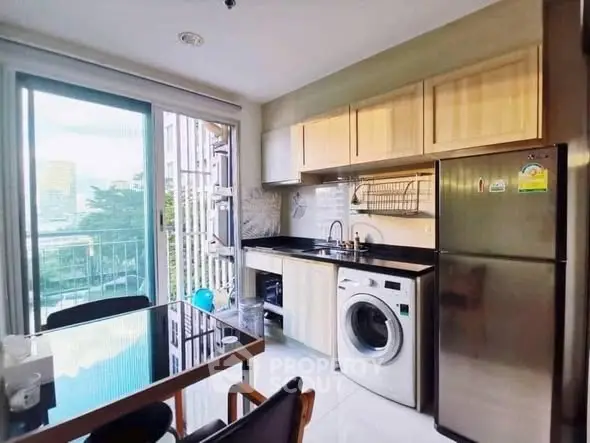 Modern kitchen with washing machine and balcony view
