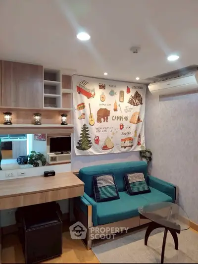 Cozy living room with modern decor and vibrant teal sofa, perfect for relaxation and entertainment.