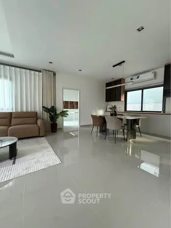 Spacious modern living room with open kitchen and elegant decor