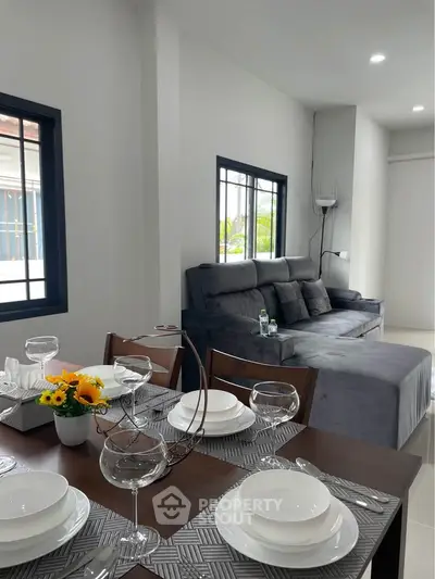 Modern living room with elegant dining area and cozy sofa