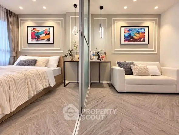 Modern bedroom with elegant decor and cozy seating area, featuring stylish artwork and ambient lighting.