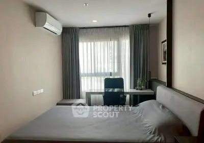 Modern bedroom with sleek design, featuring a comfortable bed and a stylish workspace by the window.