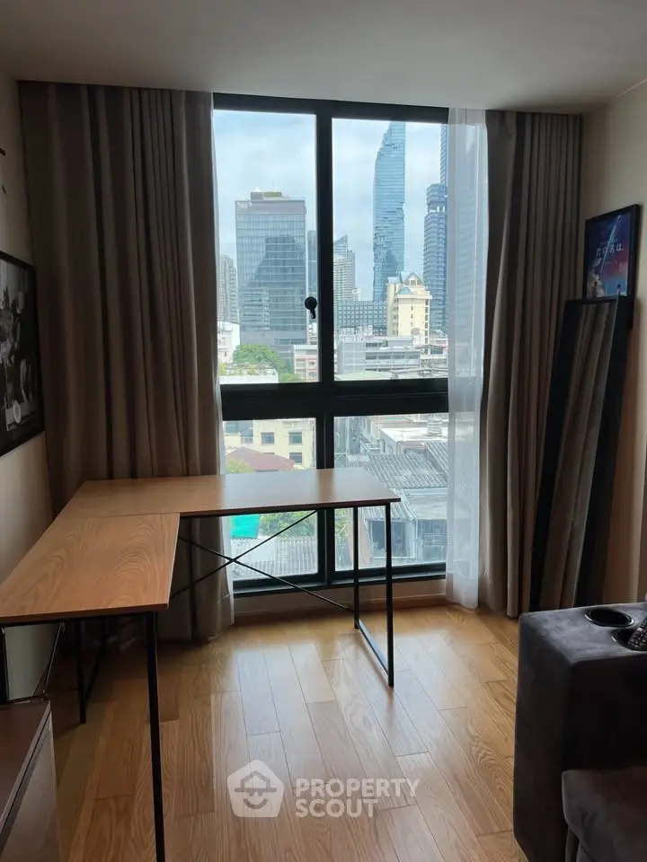 Modern study room with city view, featuring a sleek wooden desk and large window for natural light.
