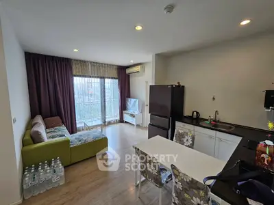 Modern living room with open kitchen and balcony view