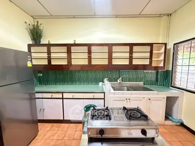 Charming kitchen with gas stove and ample storage in cozy home