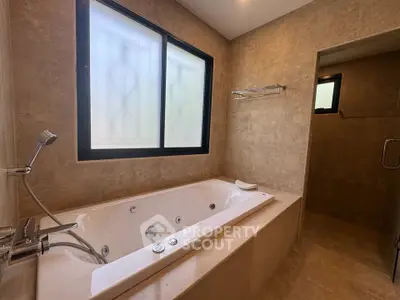 Luxurious bathroom with a modern bathtub and elegant tile design, perfect for relaxation.