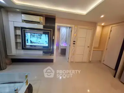 Modern living room with sleek design and built-in TV unit in a stylish apartment.