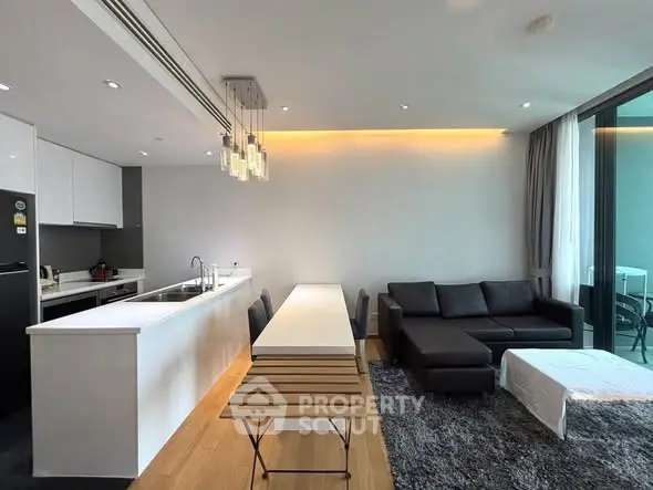 Modern open-plan living room with sleek kitchen and stylish decor