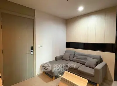 Cozy living room with modern sofa and wooden accents, perfect for relaxation.