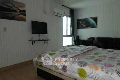 Cozy bedroom with modern decor, featuring a wall-mounted TV and air conditioning.