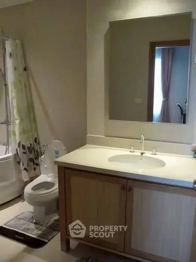 Modern bathroom with sleek vanity and bathtub in a cozy home setting.