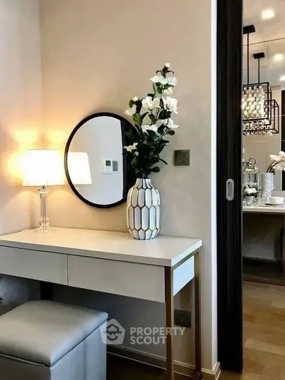 Elegant bedroom vanity with mirror and stylish decor in modern apartment.