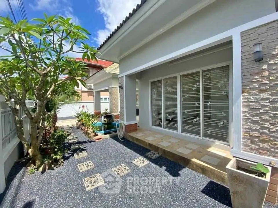 Charming house exterior with modern design and landscaped garden, perfect for outdoor relaxation.