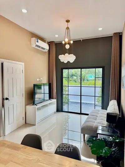 Modern living room with sleek design, large windows, and stylish furniture