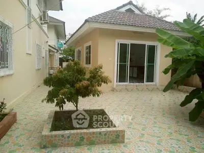 Charming single-story home with tiled patio and lush garden area